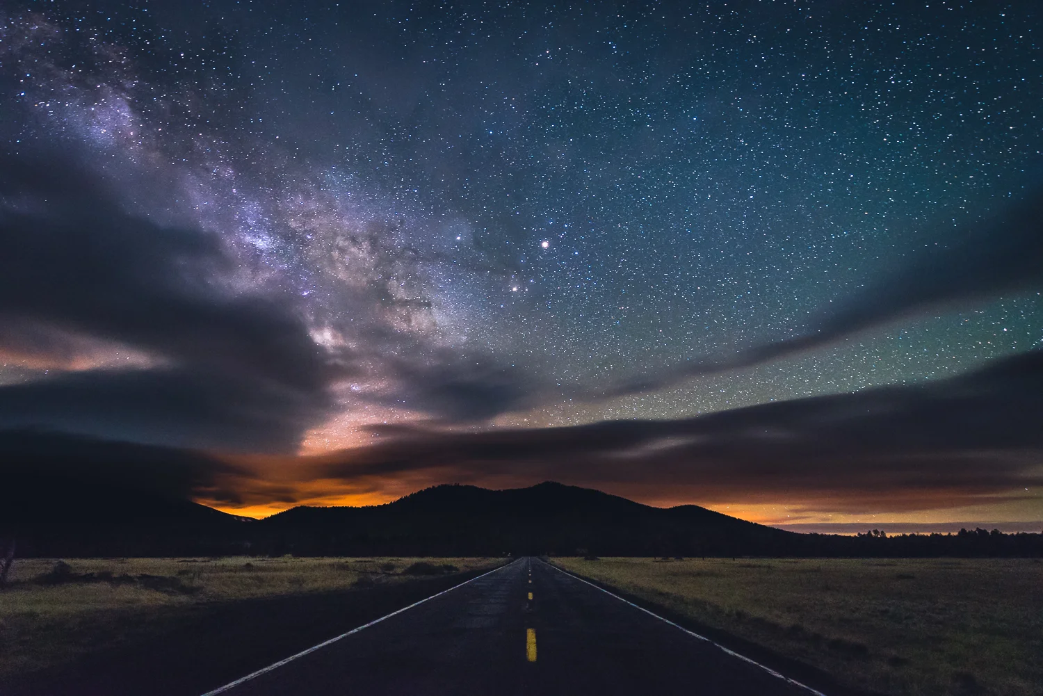 Although this photo could be considered a landscape, it could also be viewed as a unique moment in time. I had originally planned to photograph the Milky Way galactic plane passing over Humphrey's Peak (Arizona'a tallest mountain to the left and out of frame). Even though I was able to capture many shots of the Milky Way passing over the mountain, the shot above is my favorite of the bunch. The shot was taken around 2am during our last night in Arizona. It was 1:30am and I had gotten all the shots I had planned for. Before leaving though, I decided to take a shot looking directly down US Route 180, the road I had pulled over on to take the shots. Since it was the middle of the night, there were no cars around for miles leaving me ample time to take the 25 second exposure required to photograph a starry sky. The photo has several points of interest; the long straight roads of the southwest, the mountains, the orange sky glow of Flagstaff 30 miles to the south, the planet Mars shining brightly directly over the roadway, and the Milky Way galactic center peaking out from the clouds on the left of the frame. That night, I did not get much sleep after getting back to the hotel at 3am. Despite that, it was all worth it to get of my favorite shots of the year. 