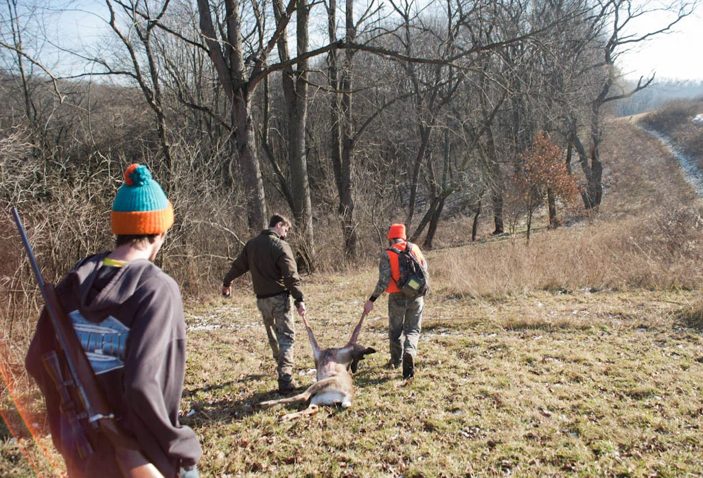 (January 5th 2012) Young hunters of Western PA drag the carcass of a deer they tracked all morning and most of the afternoon back to their property over the hill. 