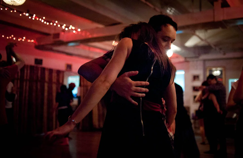 Two dancers in the NYC Fusion dance community find a close embrace during a "Melting Pot" social dance on a Saturday night.