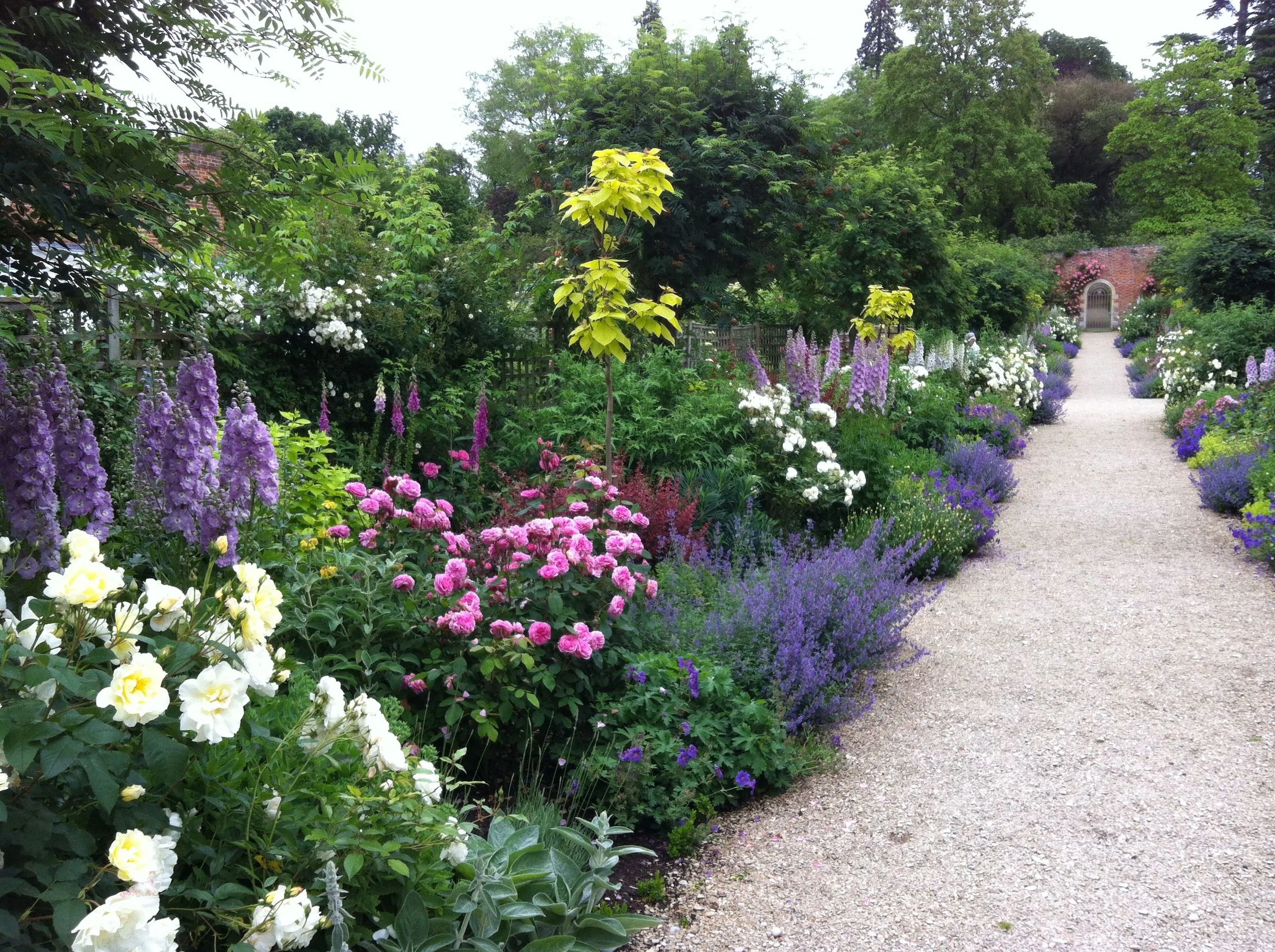 The Peter Coats Border at Buscot Park - a mixed shrub and herbaceous border, producing colour from tulip season through to Autumn shades.