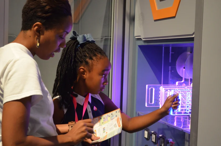A S.E.C.R.E.T. agent and her parent reprogramming the S.E.C.R.E.T. Mainframe. Photo by Anisha Deshmane.