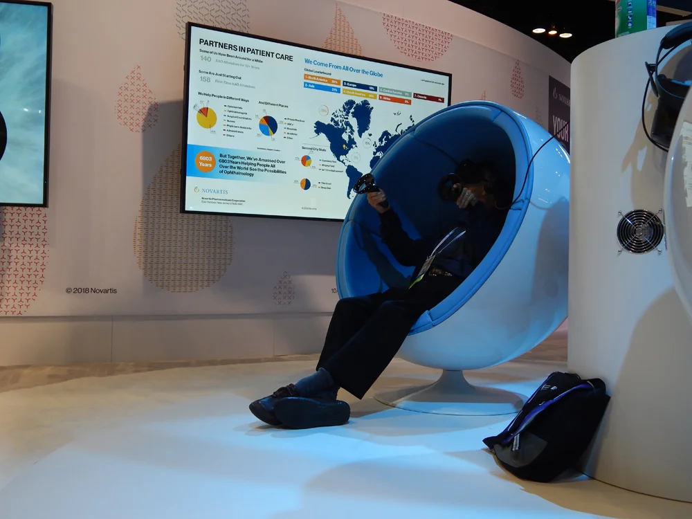 Before leaving the Novartis Welcome Portal, attendees were encouraged to answer a few questions via touchscreen. The results were projected on a screen deeper inside the footprint. Strategic placement of the infographic and collage of attendees’ eyes allowed Novartis greeters to drive guests further into the exhibit. In this photo you can see the consumer listening infographic next to one of the virtual reality stations.