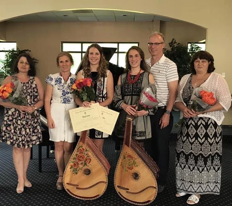 Uliana with Family and teachers  2.jpeg