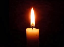 Single lit candle against a dark background