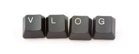 Four dark grey computer keys in a row that spell out VLOG