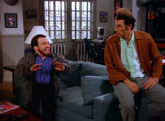 Seinfeld characters Mickey Abbott on the left, Kramer on the right, talking in Jerry's apartment