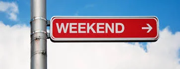 Photo of a red street sign with white block letters reading "WEEKEND"