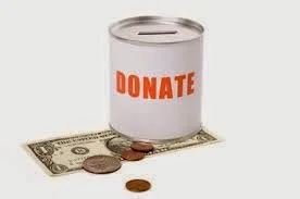 Photo of a donation can sitting on a dollar bill with some coins