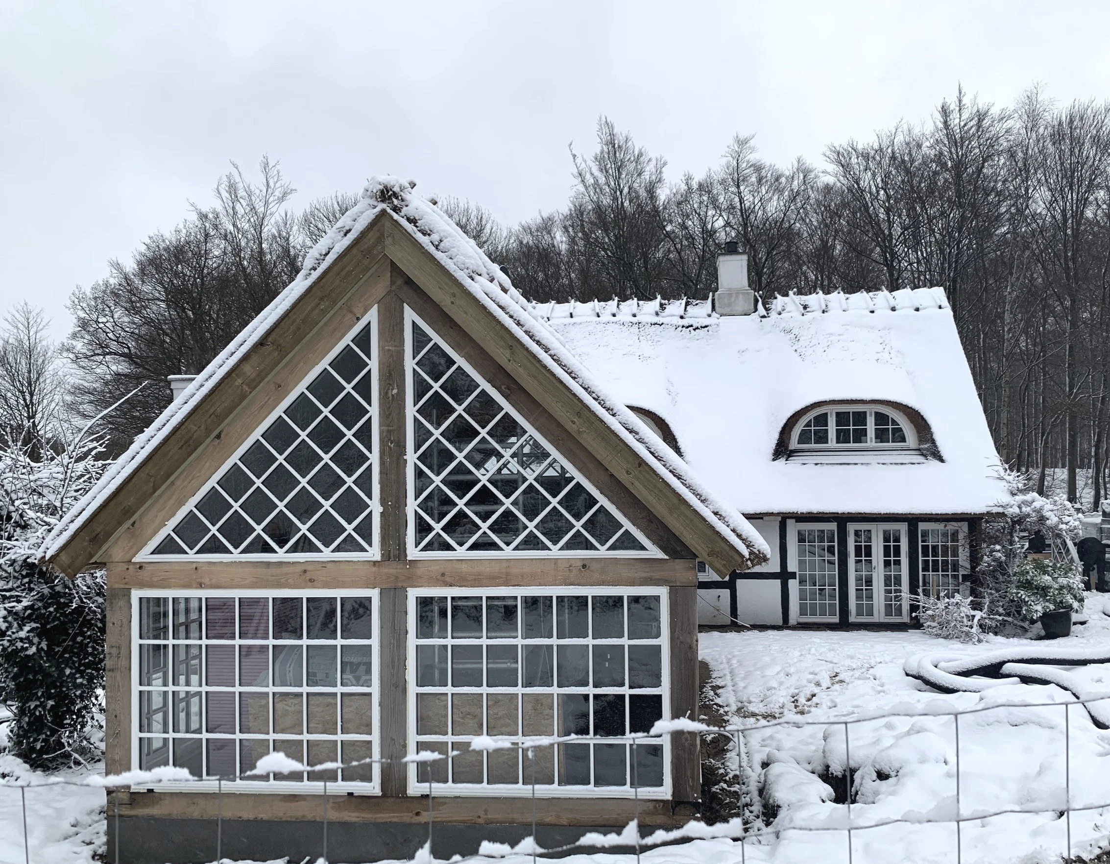 Thatched roof house in the snow