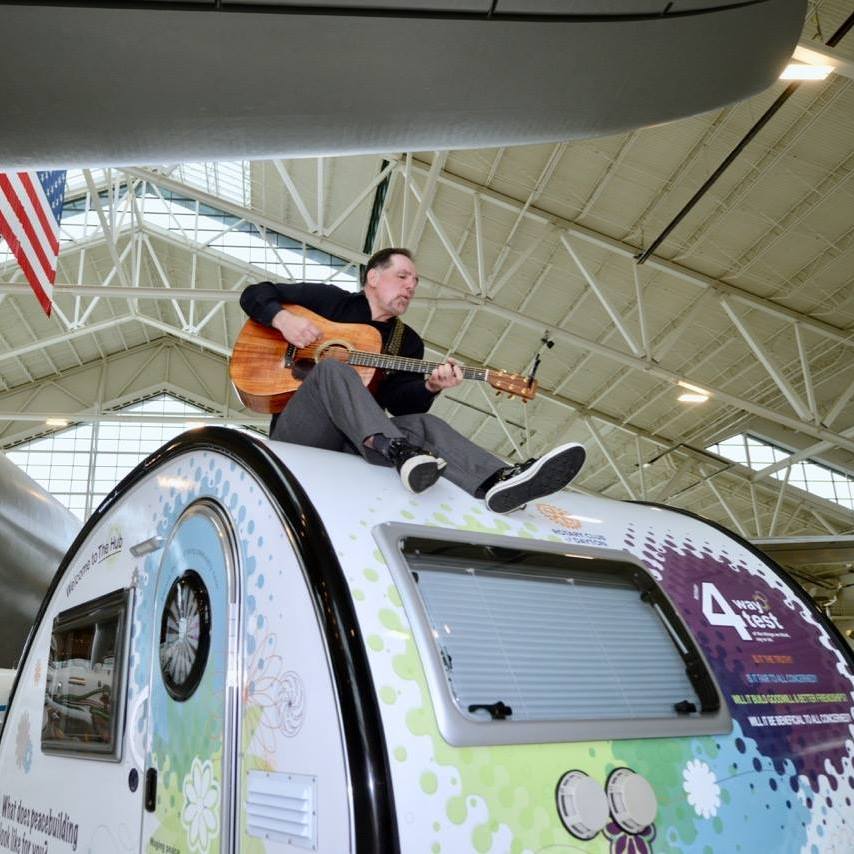 Jerry Leggett performs for peacebuilders beneath the Spruce Goose at the Evergreen Aviation and Space Museum in McMinnville, Oregon. (Photo credit: Patsy Ferrell,©2017, Used with permission)