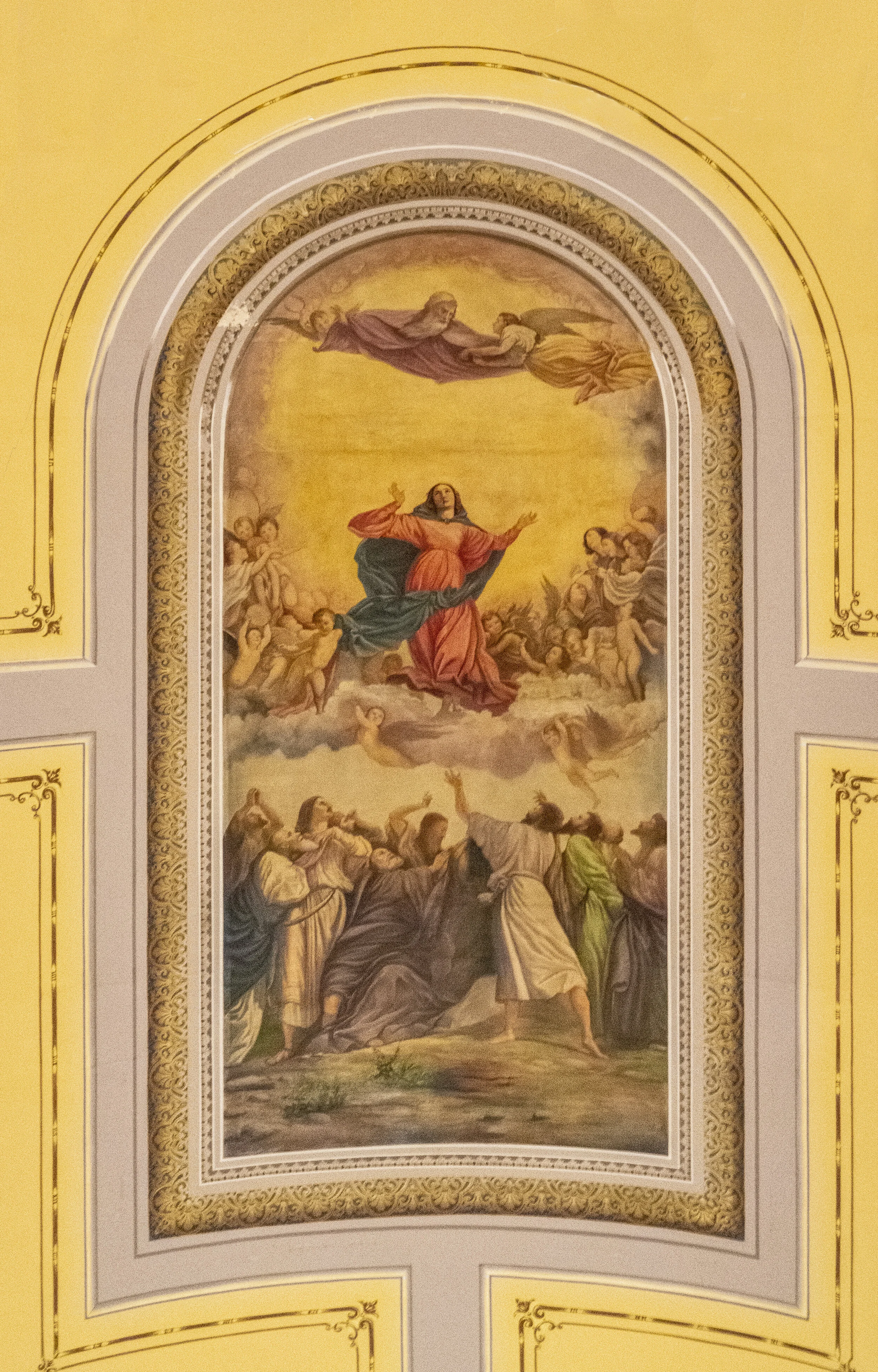 The Church's ceiling (center) portrays the Blessed Mother Mary ascending into heaven while the faithful below beseech her help.