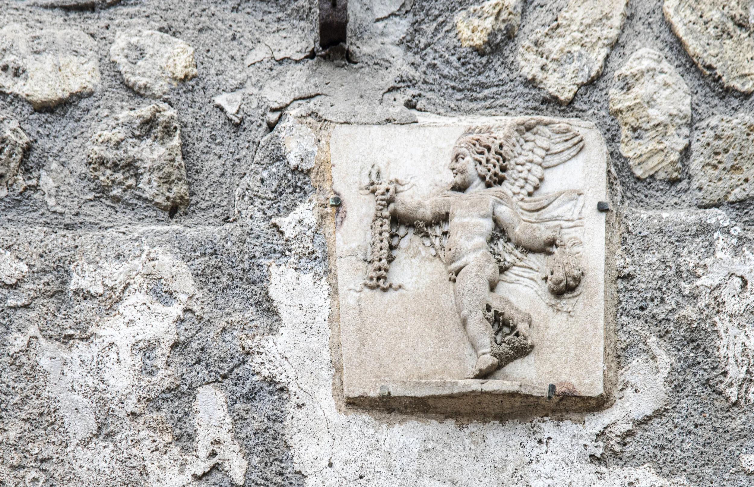 Casa dello Scheletro wall basso-relievo possibly the Greek goddess of victory Nike (the Romans called her Victoria).