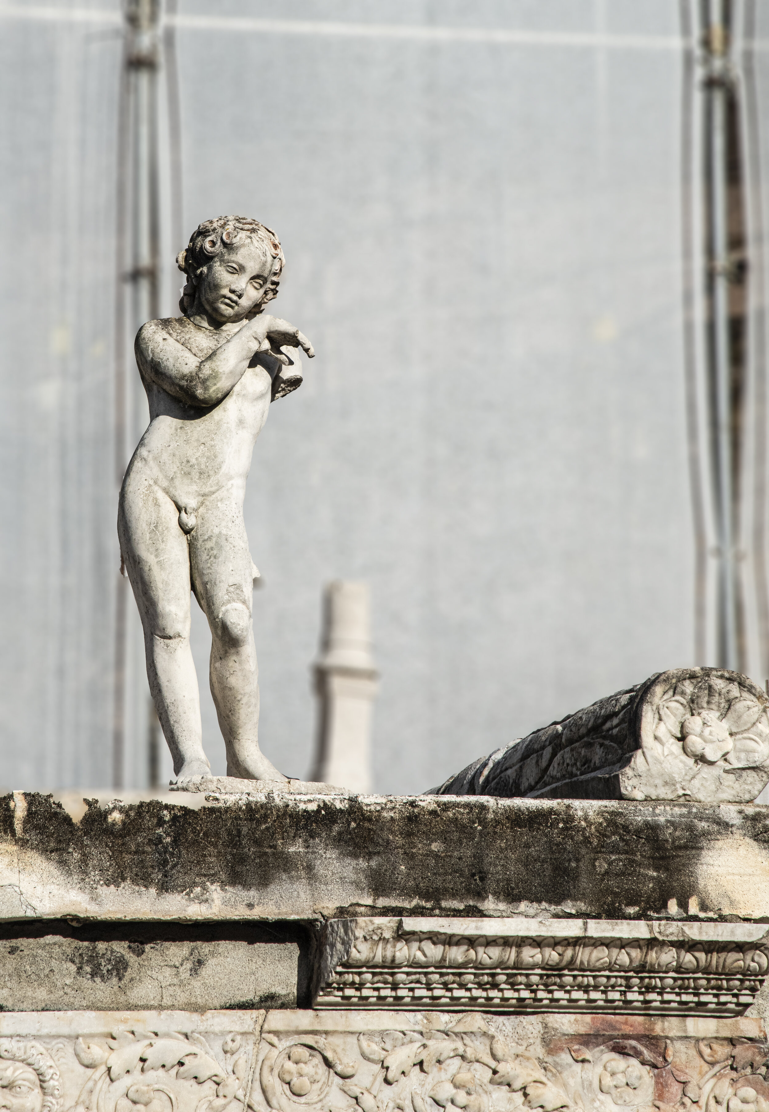 Suburban Bath courtyard (palaestra): As part of the monument (cenotaph) to M. Nonius Balbus, there are two sleeping marble cupids (one seen here) holding torches head downwards.
