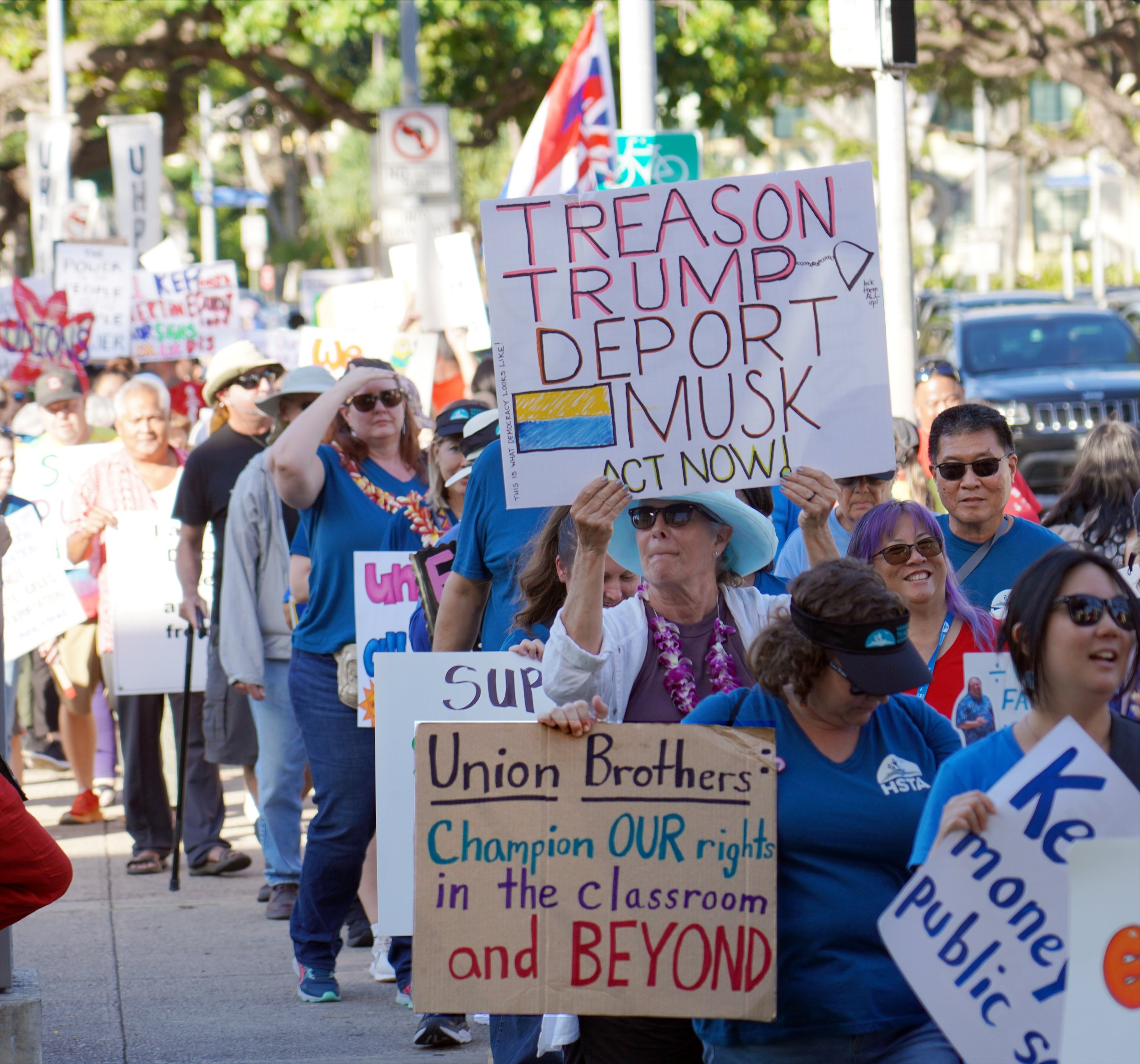 Individual signs calling Trump's acts treasonous and asking for union support of teachers' rights in the classroom