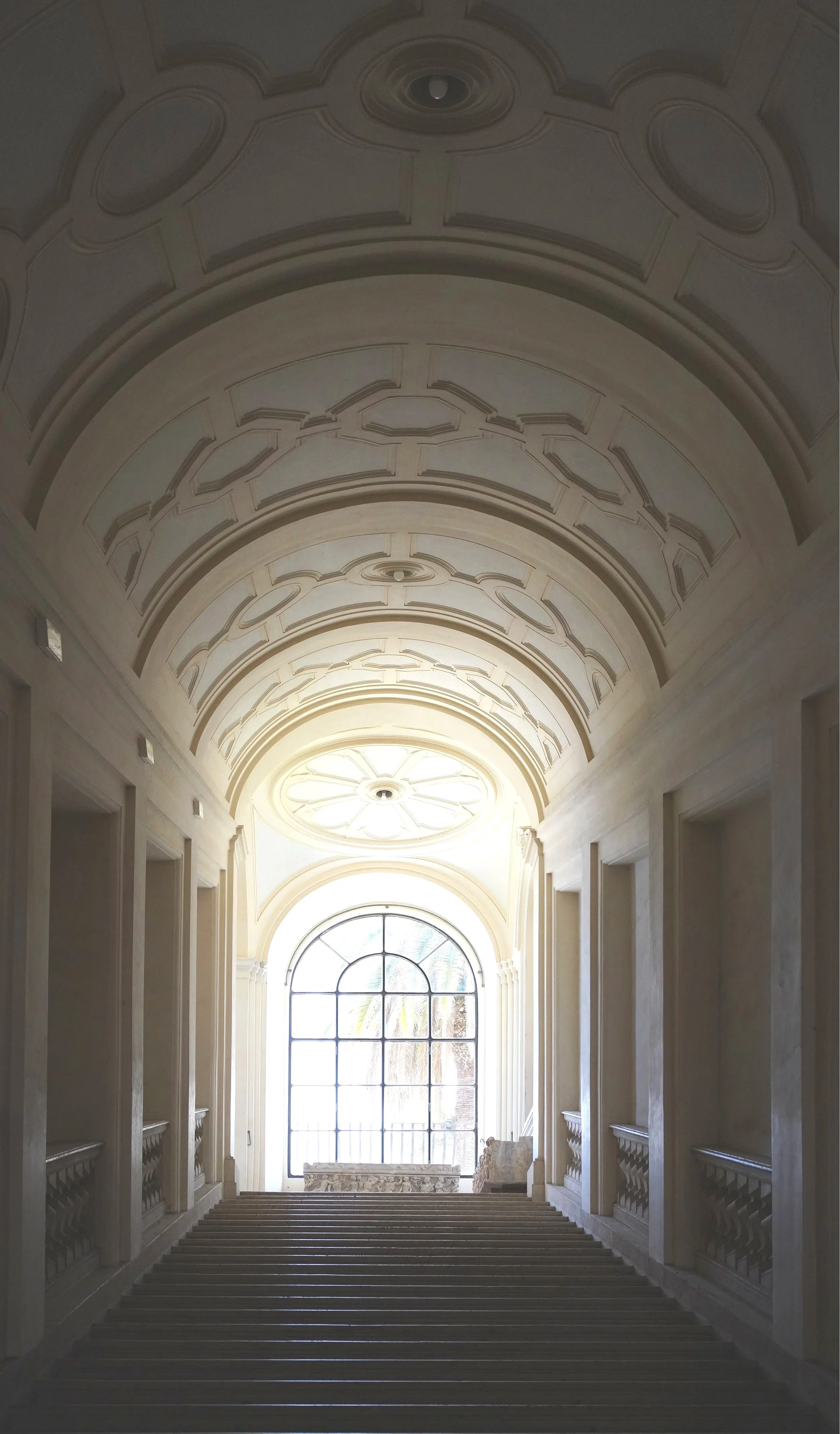 Staircase to Corsini galleries with a sarcophagus at the top.