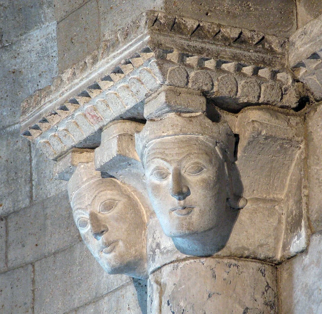 Crowned heads, carved on right-hand capital at the juncture of the apse and nave, Langon Chapel