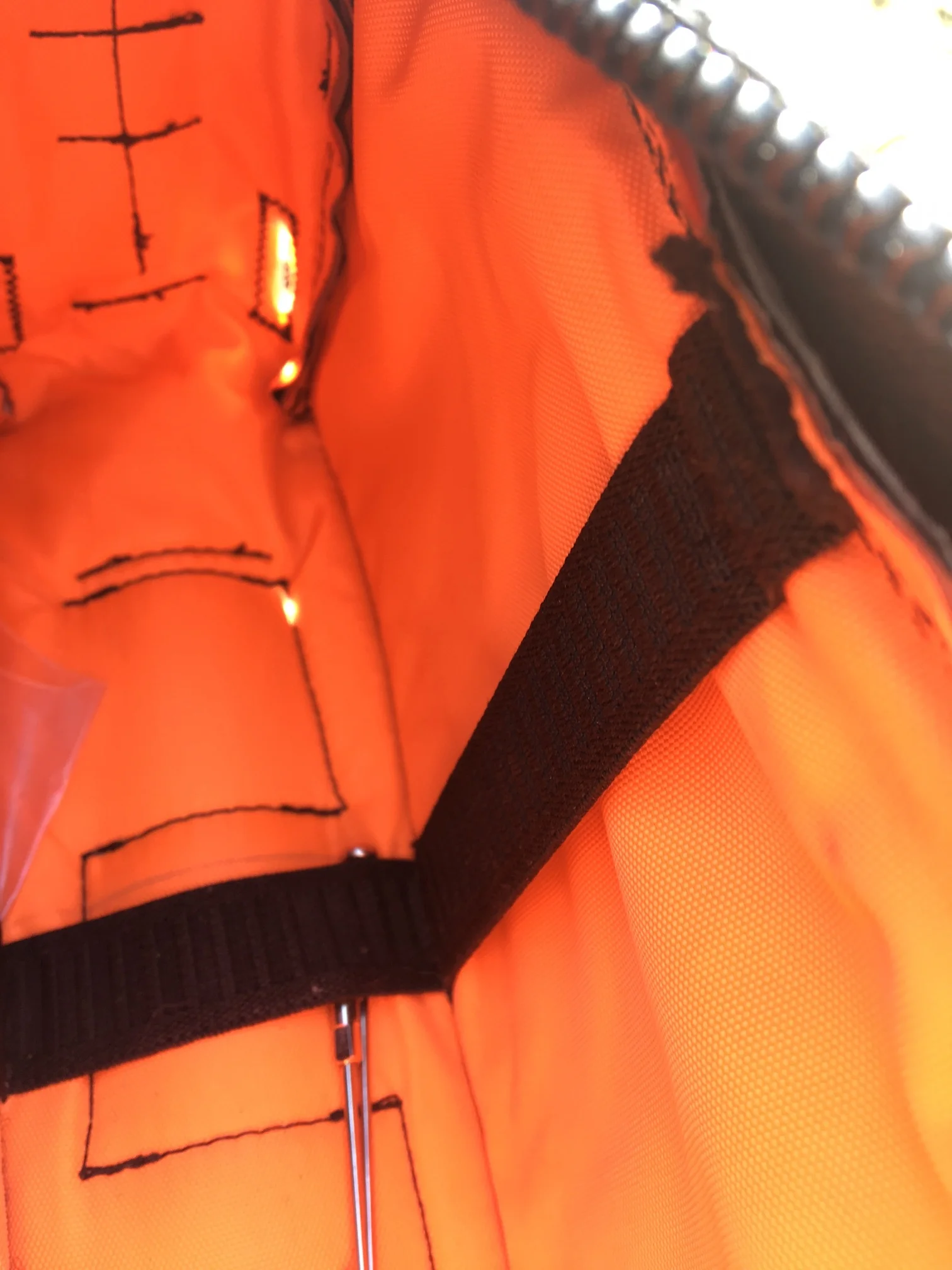 My cache battery will be held by this strap, with the wires exiting at the port seen at the front of the bag. Super slick. 