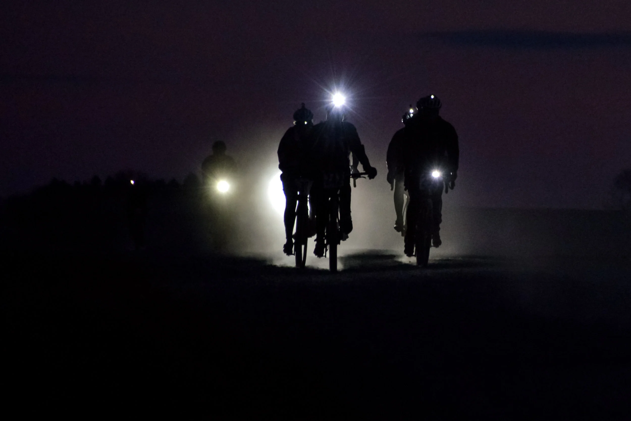 Riding gravel at night can be a wonderfully focused experience. Sharing the dark miles makes them a little brighter. Photo by Jon Duke. 