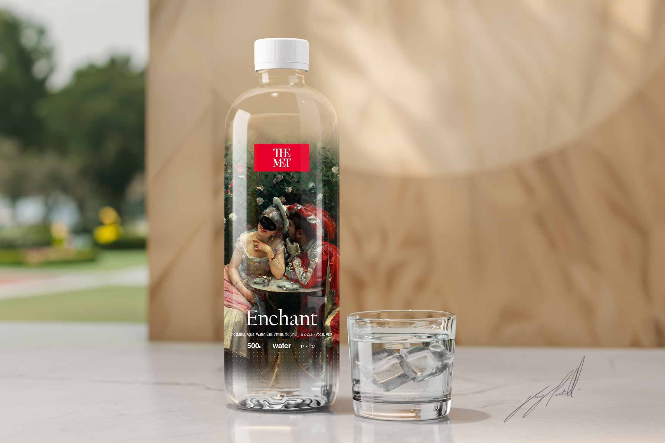 A water bottle labeled 'Enchant' with a photo of two people dressed in costumes, one with a mask, sitting at a table outdoors. Next to the bottle is a glass of water with ice cubes. The background shows a blurred outdoor scene.