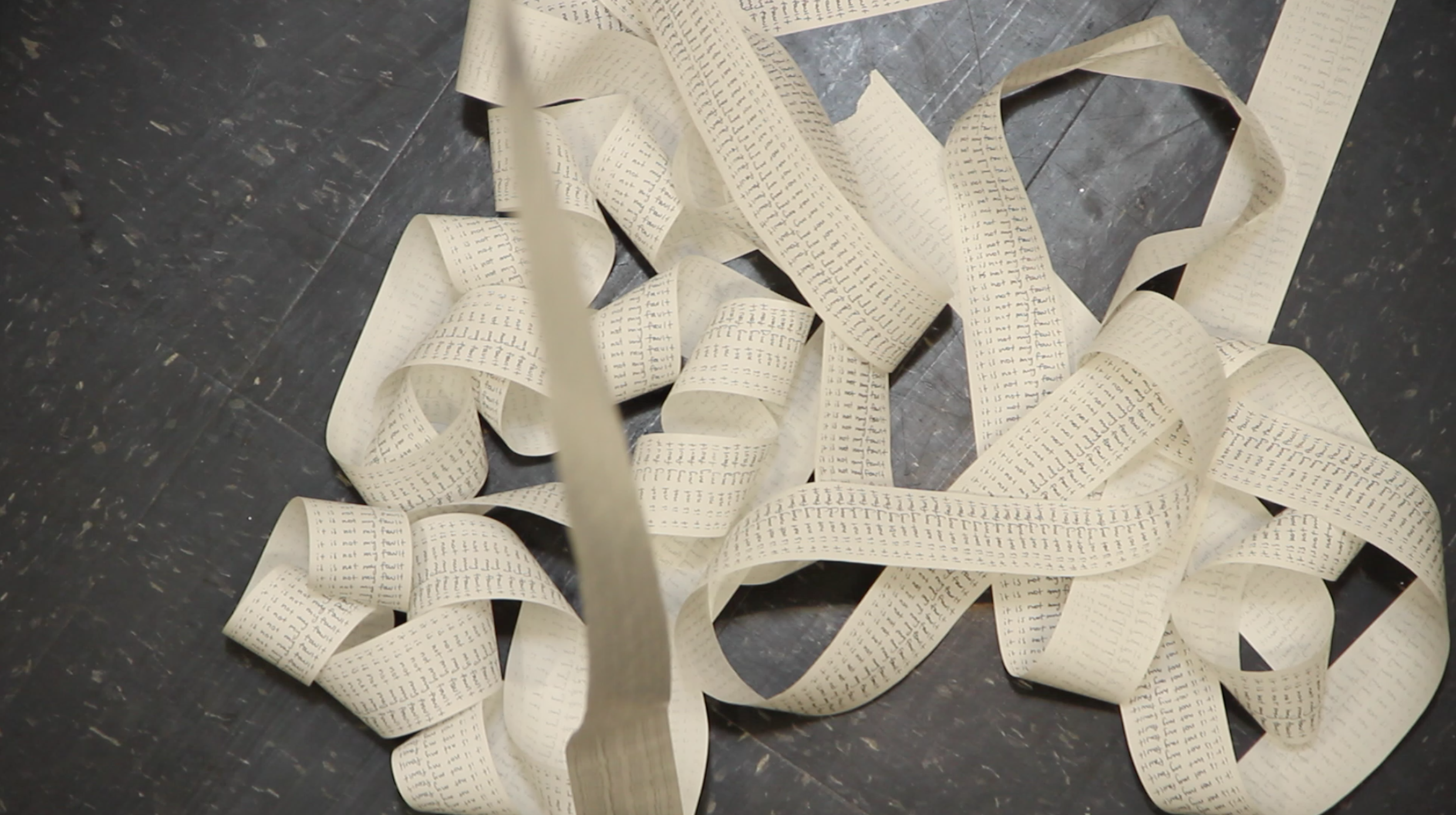 Pile of receipt tape with It is not my fault repeated in Boston MA Shannon May Mackenzie photo