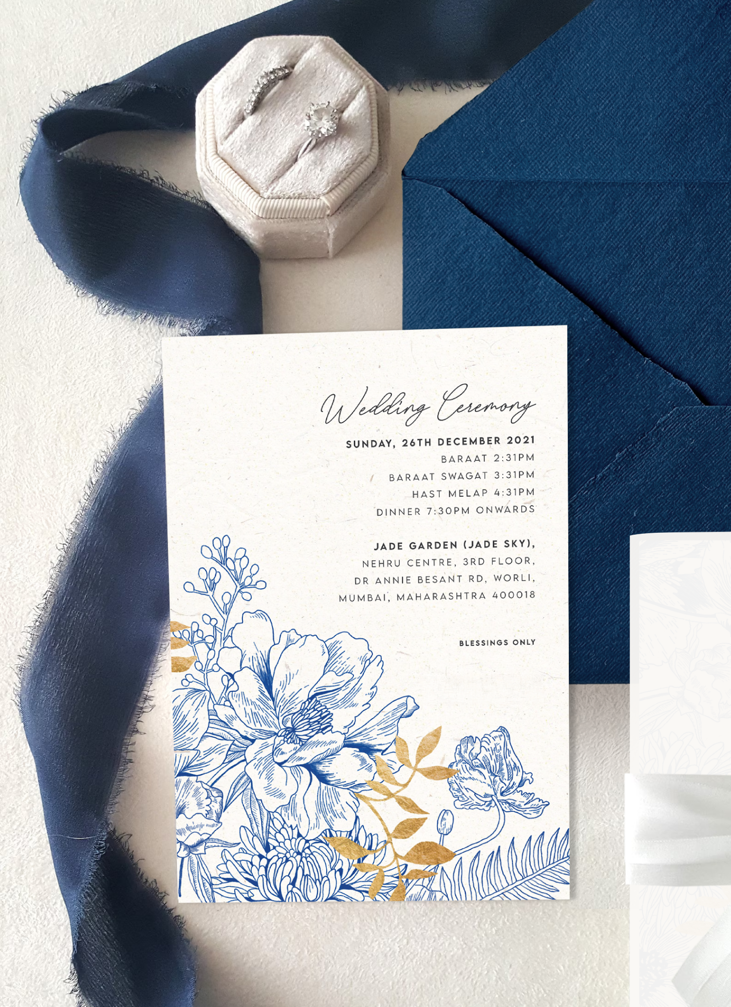 Details in the florals paired with gold, printed on recycled paper; frayed edges of the envelope; vellum paper with a satin ribbon and a blue wax seal set a perfect tone for this wedding day.