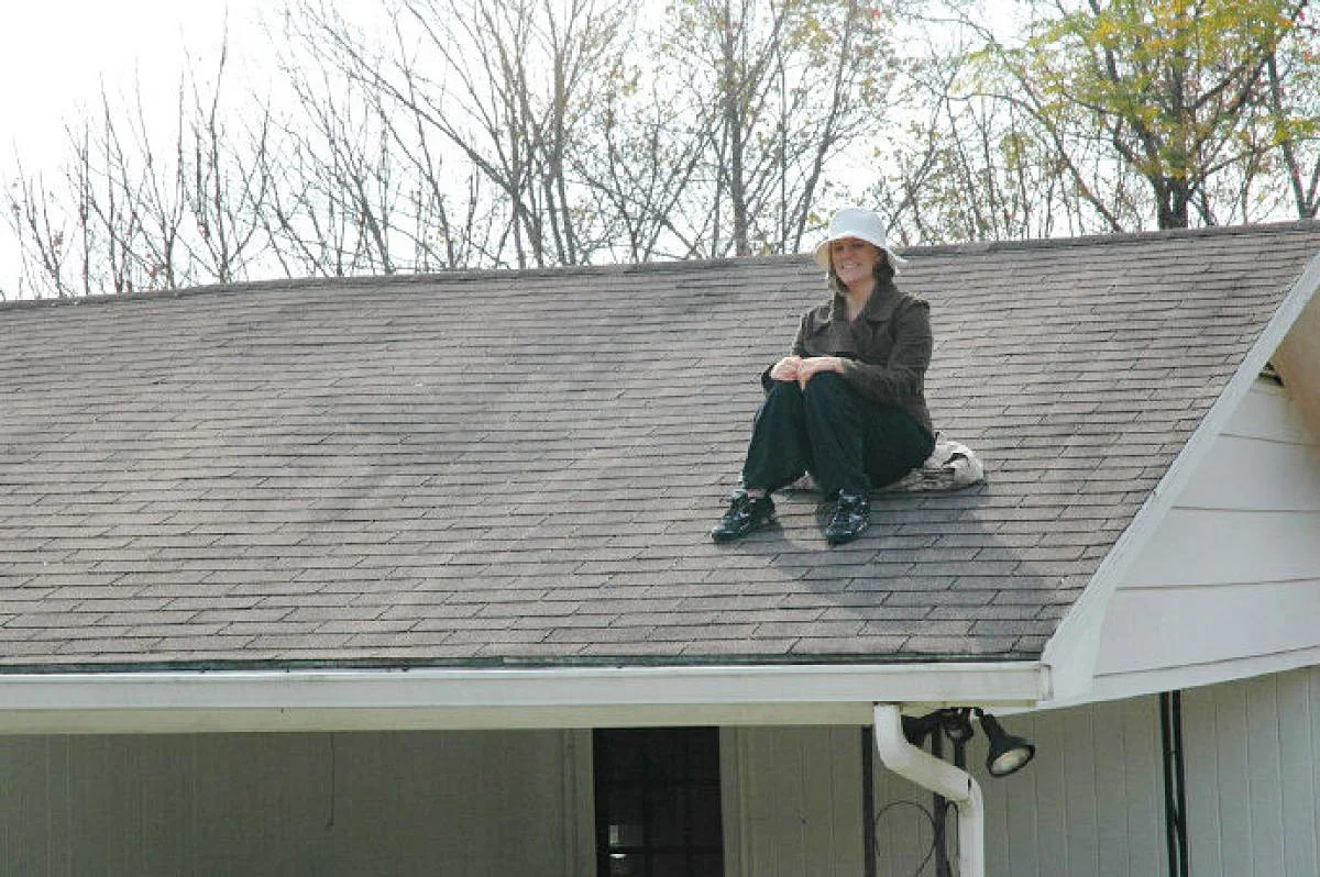 Rachel Held Evans, for being a contentious woman, sits on the roof of her house during the year the Christian feminist tried to live according to the rules of the Bible