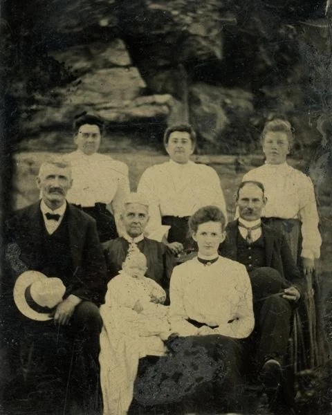 L to R back row: Lizzie Hopkins Harris, Susan E. Hopkins Harris, Harriet Hopkins (daughters of Susan &amp; Ira Hopkins). Front row: Ira W. Hopkins, Susan D. (Harris) Hopkins, probably Howard Fenner Jr., Cora Wade (Harris) Fenner, Howard Fenner. Photo courtesy of Tammy Vincent.