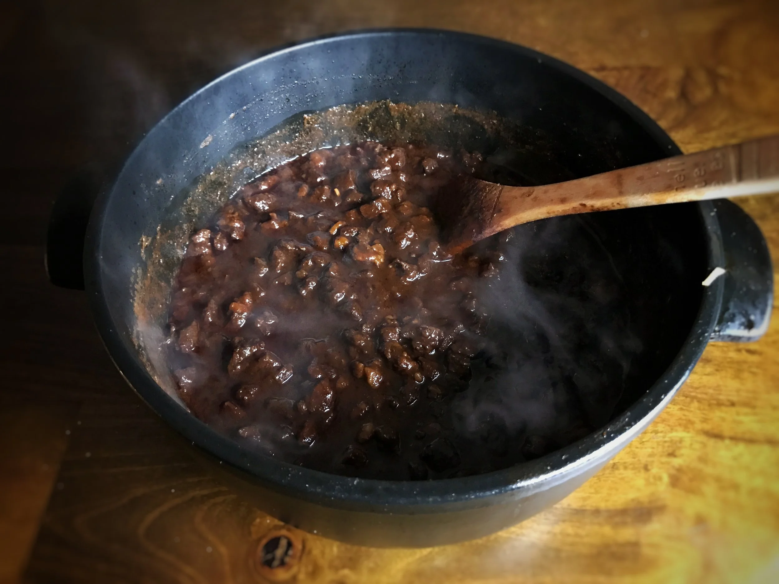 Chili in pot on wood.jpg