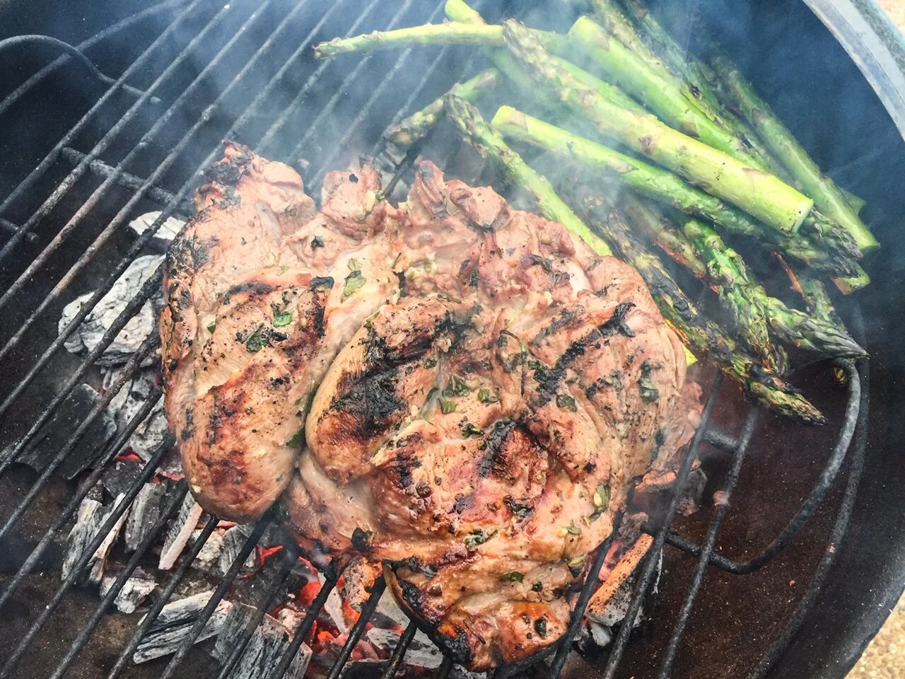 Butterflied leg of lamb on grill.JPG