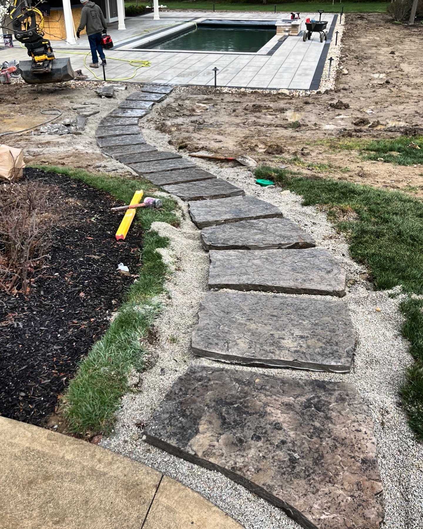Natural flagstone walkway in progress. 

This pathway will cut through the lawn and keep feet clean going back and forth to the pool. After the irrigation is installed we will remove a lot of the bedding between the stones to allow for more soil dept