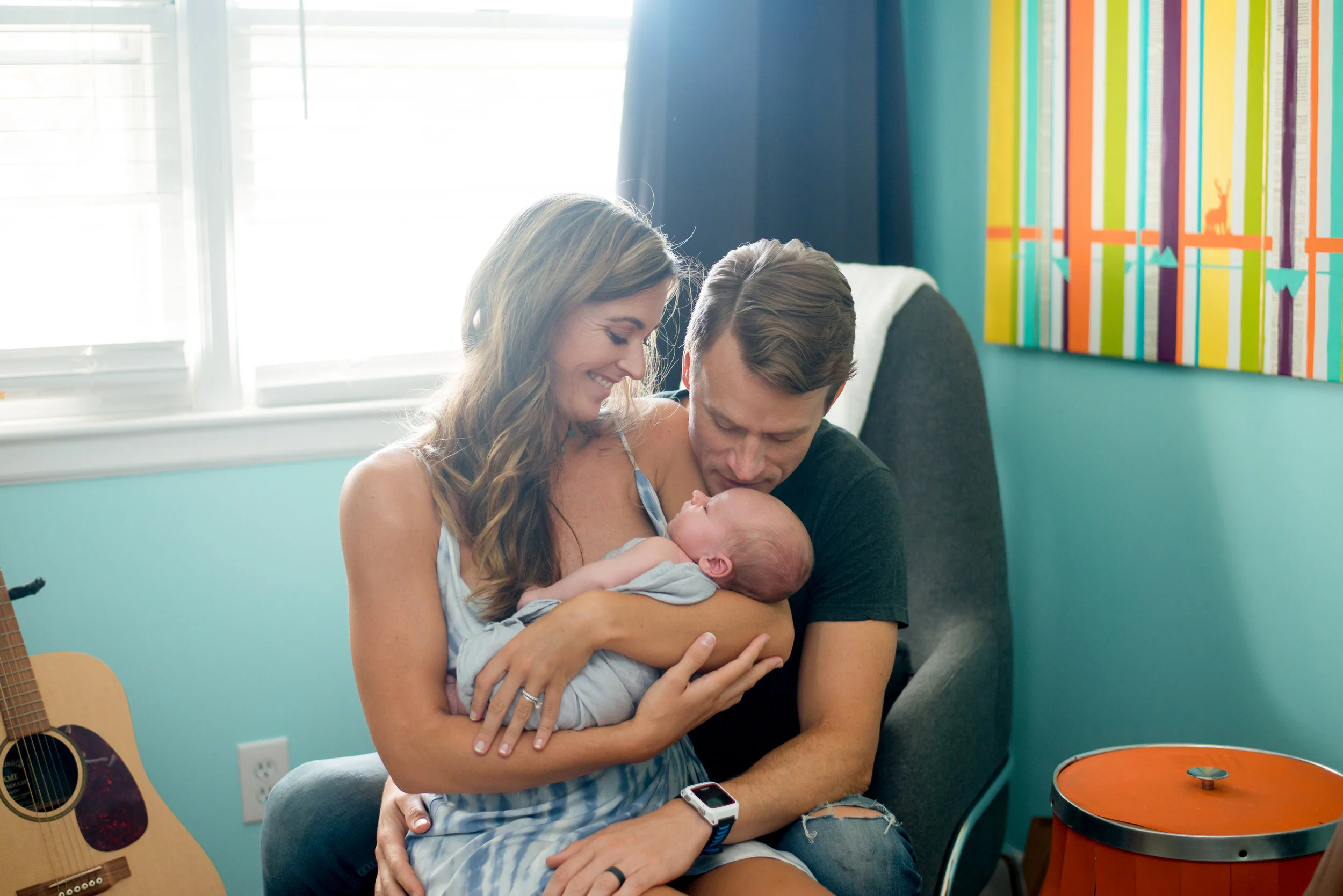 parents cradling newborn in family portrait session Wilmington nc