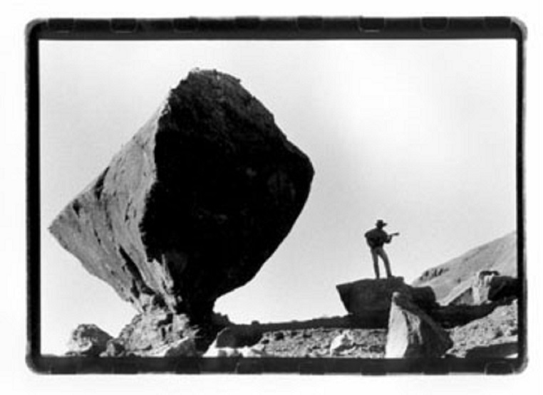 Peter McLaughlin at Vemilion Cliffs National Monument with guitar and balanced rock.JPG