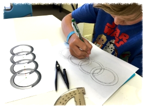 Riley applies geometry knowledge to draw car logos.