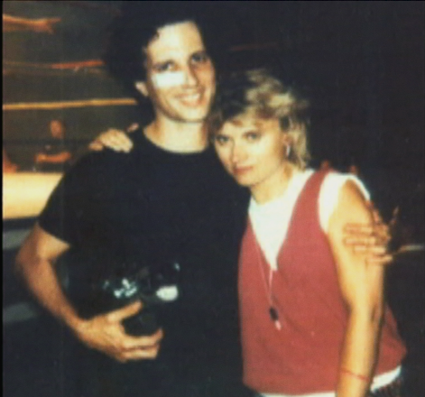 A BATTLE-SCARRED ALLAN HOLZMAN, HOLDING HIS TRUSTY 16MM BOLEX CAMERA, WITH WIFE SUSAN JUSTIN, WHO COMPOSED THE MUSIC FOR GRUNT! THE WRESTLING MOVIE.
