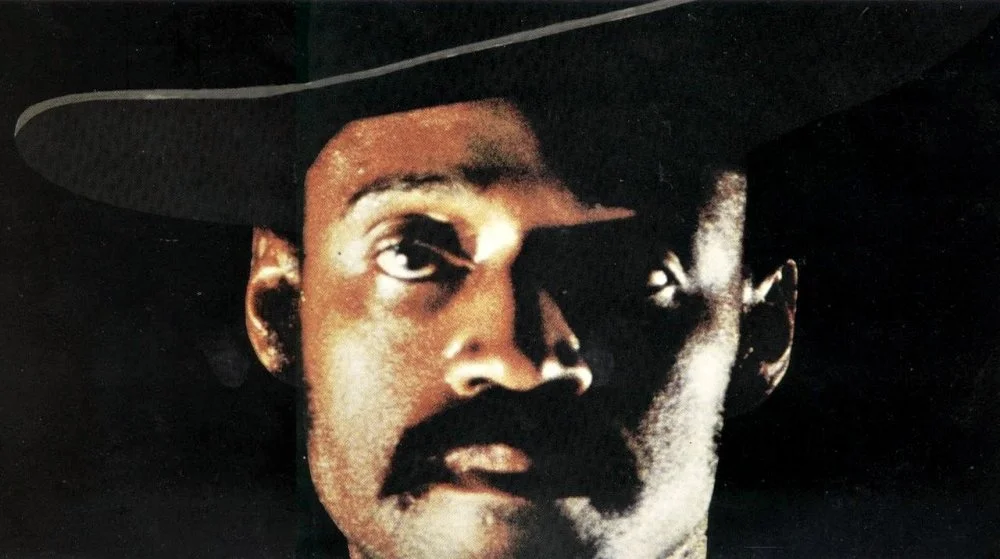sweet-sweetbacks-baadasssss-song-1971-001-melvin-van-peebles-in-cowboy-hat-close-up-black-background_0.jpg