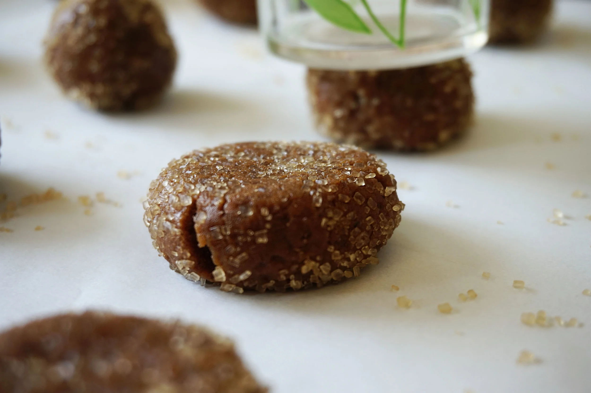 With the bottom of a glass, slightly smash down the dough balls.