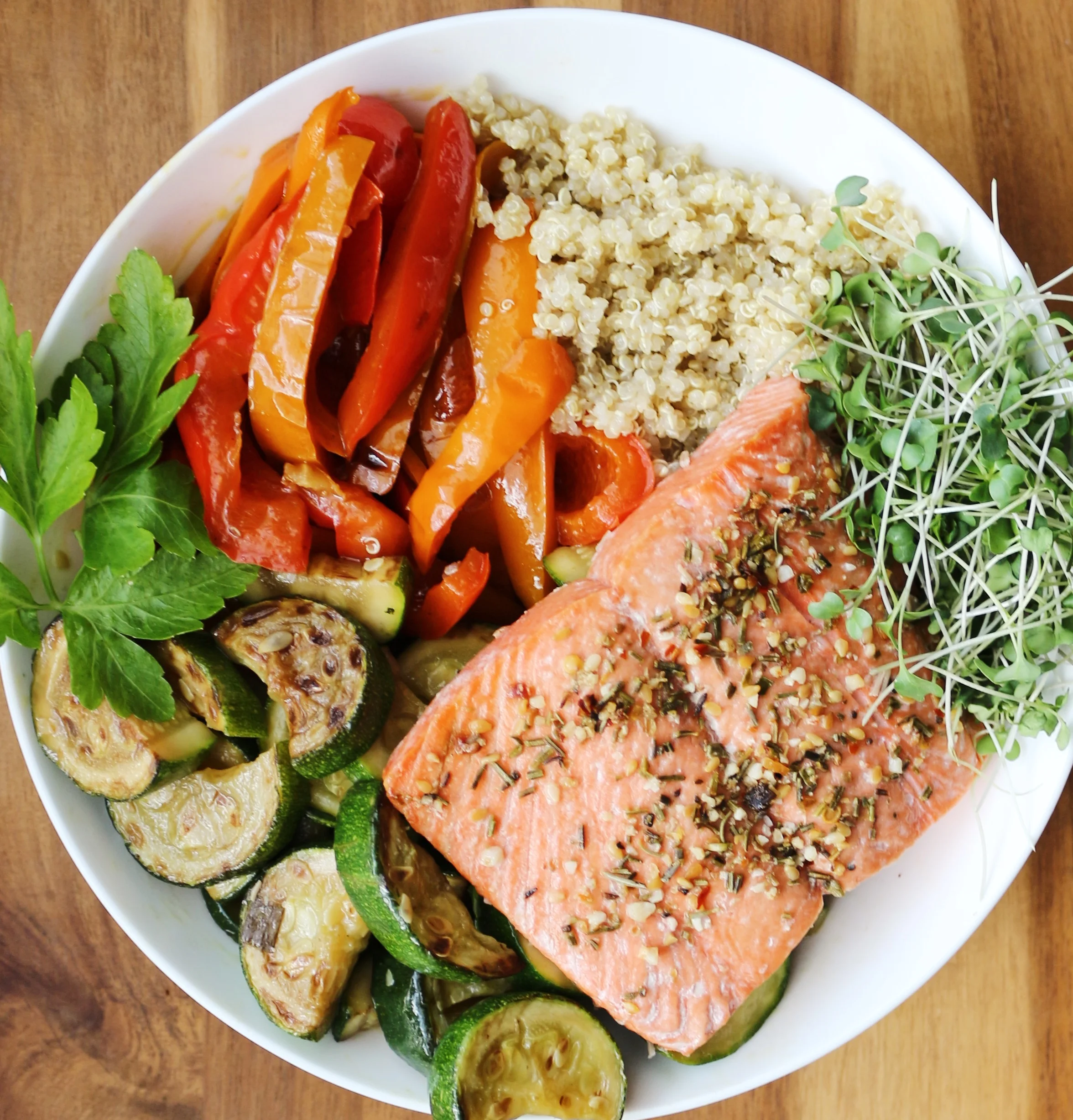 4 oz. of baked salmon with roasted zucchini and bell peppers, quinoa, andmicro greens