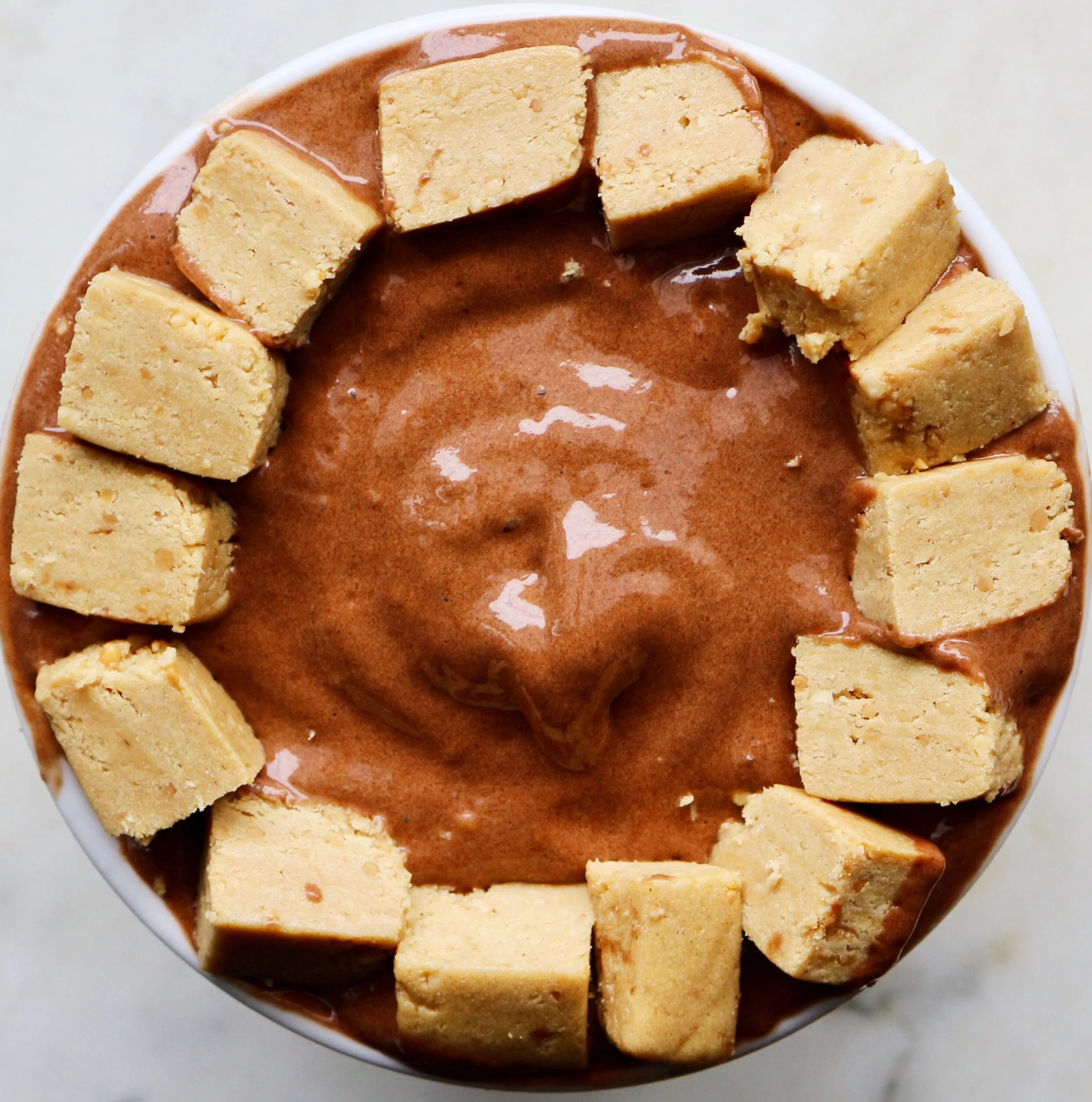 Chocolate Protein Banana Ice Cream: 3 frozen bananas + 1 scoop chocolate protein + ¼ cup almond milk. I cut up a peanut butter Perfect Bar for the topping.