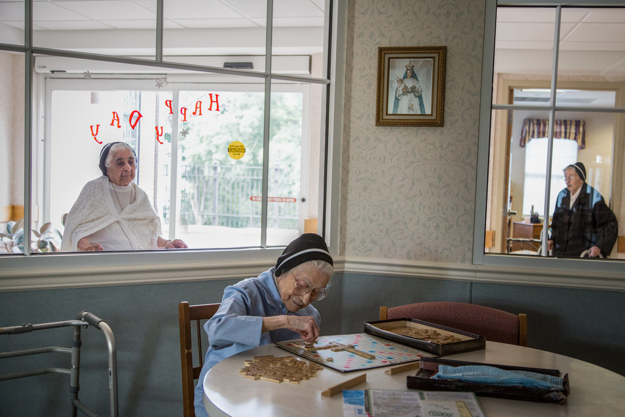  At 100 years of age, Sr. Mary Testa enjoys playing Scrabble every day in the Infirmary’s Community Room. The scattered tiles spell words related to teaching such as: schools, teachers, pupils, books, girls, boys, and years. 