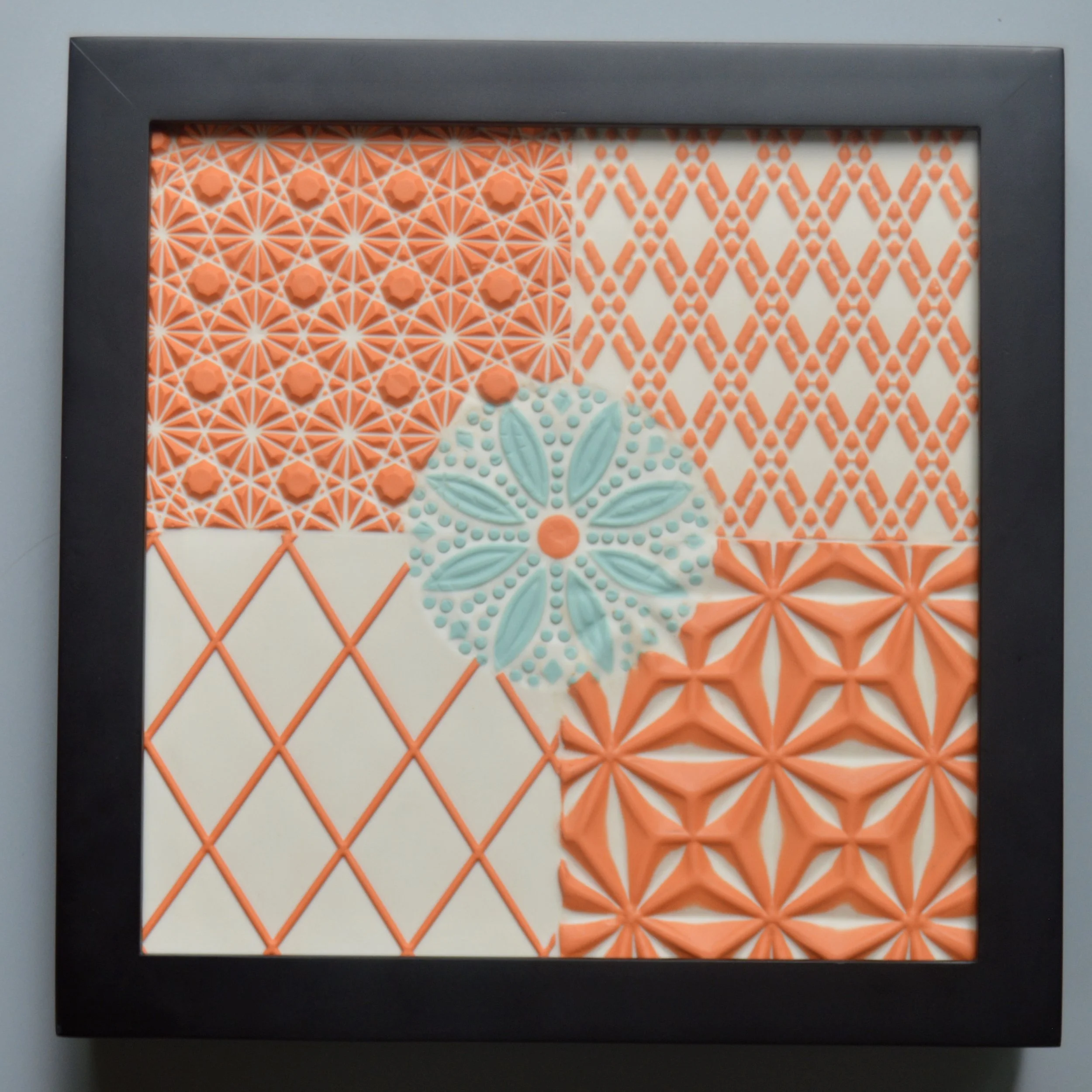 4-Pattern Tile with Turquoise Flower in black gallery frame. 8"x8"