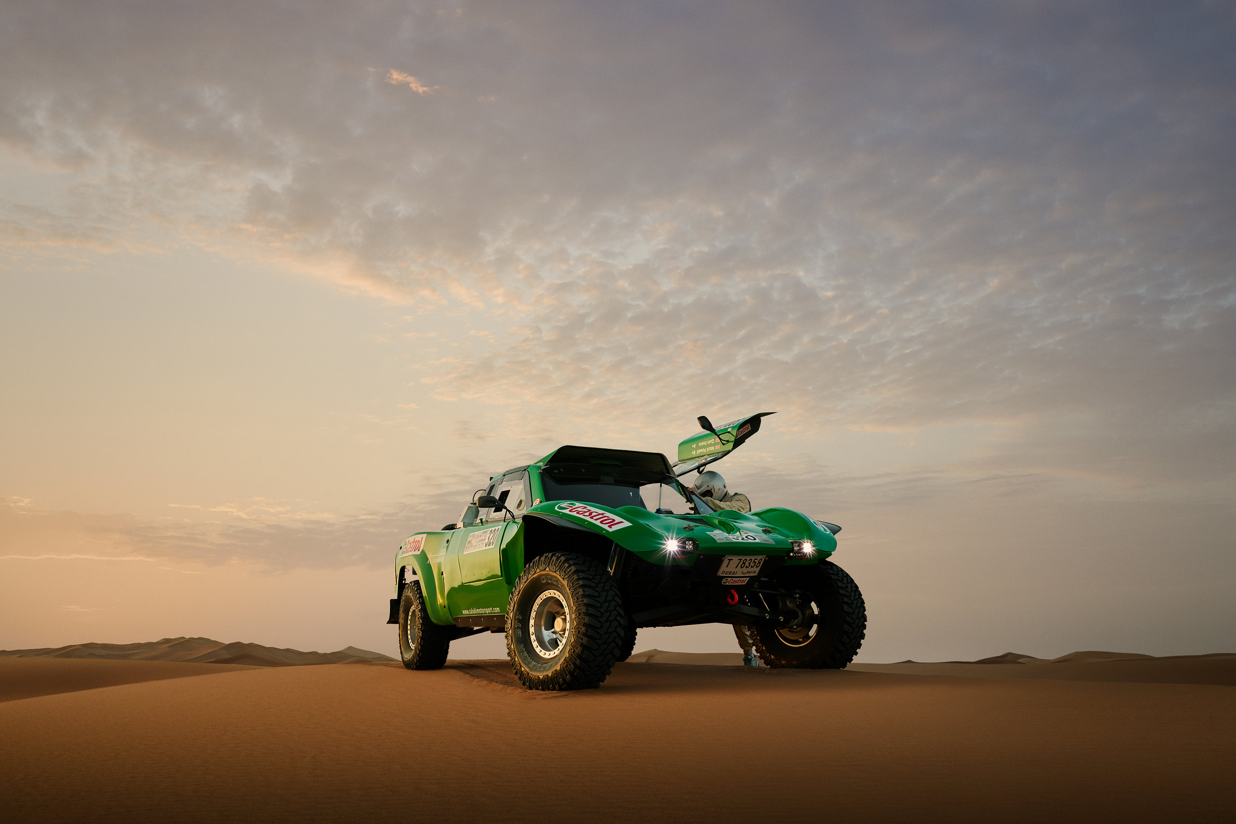 Dawn in the middle of the desert near Dubai with Mark Powell. Who wasn’t present for this shoot was Mark’s co-driver. While co-drivers don’t actually drive the car, they are equally responsible for the final success or failure of the race. Rally car racing is the only motorsport in which drivers race blind, going from Point A to Point B with no real idea of what’s in front of them. And that’s where co-drivers play a critical role. They are the navigators and the true eyes of the driver. Reading off a highly detailed set of directions called pace notes (which can be encyclopedic in size), the co-driver will tell the driver where to turn, when to turn, what to look out for and what’s ahead over the next dune. It is a highly complex, trusting dance between driver and co-driver. Using a crazy shorthand, which to the untrained ear sounds like gibberish, a co-driver can give his driver an enormous amount of information instantly - "100k left 2, 100k right 2, 2000 square left, 100k right 4, 50 caution jump into right 2 tightens, don’t cut, 100 oversquare right, 400 flat to crest into k left 4.” And that’s just ten seconds of instructions. Imagine having to do that for 8 hours straight all while racing at speeds of 120 mph or more? Fantastic stuff. 