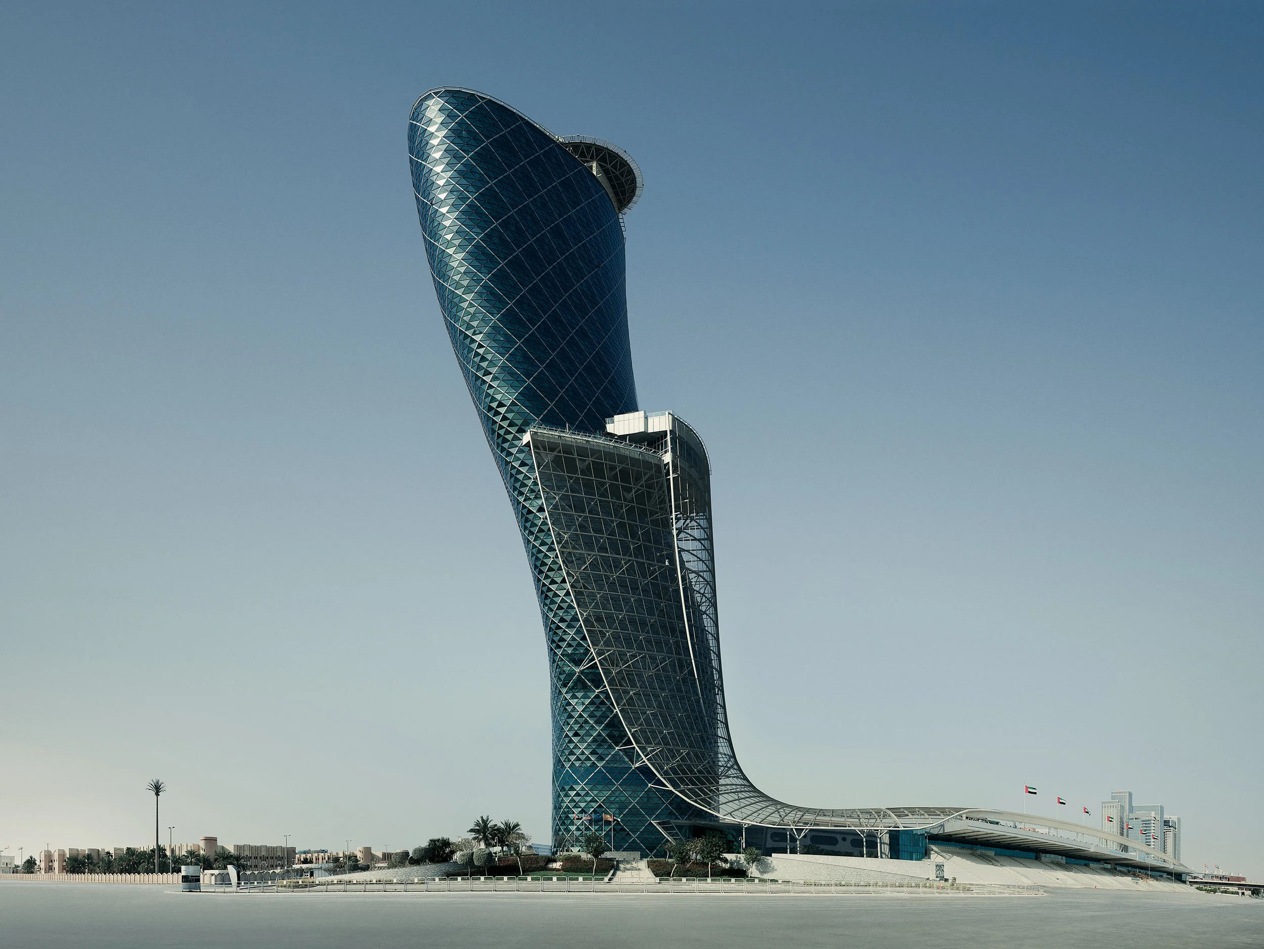 While I don’t consider myself to be an architectural photographer by any stretch of the imagination, I am drawn to compelling design regardless of function. As a result I am occasionally asked to photograph architecture. Most recently, as part of an extensive campaign for Strawberry Frog, New York, I had the opportunity to shoot Capital Gate and Ethiad Towers in Abu Dhabi, U.A.E. In a city known for its vertical outlandishness and neck-craning beauty, there may not be a skyscraper more outlandish than Capital Gate (pictured above). Known as the Leaning Tower of Abu Dhabi, it was constructed INTENTIONALLY to incline eighteen degrees - versus the Leaning Tower of Pisa, which only tilts five-and-a-half degrees as the result of UNINTENTIONALLY poor foundation. As the result, Guinness World Records certified Capital Gate as the world's “farthest manmade leaning building.” Crazy.