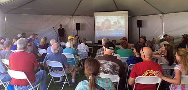 Audience looking on as Chris Servheen gives presentation on grizzly bear recovery