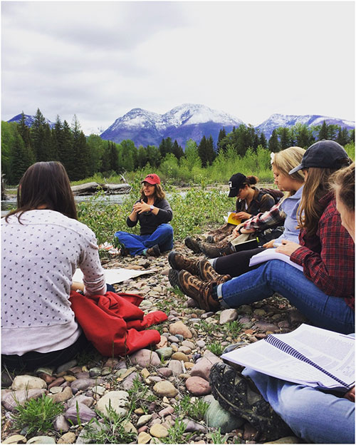 Instructor Andrea Stephens explains watershed dynamics to the students on the Swan River