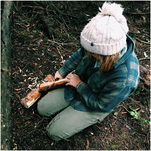 Aspen working on feather sticks