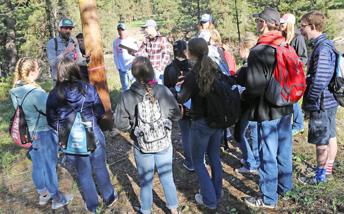 Students joined Adam Lieberg and Sara Halm from Swan Valley Connections where they put their tracking skills to the test along the river corridor. They visited a series of points and were asked to identify what animal left the sign and why the sign was left, either eating, reproducing or communicating. Then on the return trip, they were given the answers to questions so they could compare. At this point, a bear used its canine teeth to scrape the power pole. Halm said it is a communication tool. "Communication is one thing we don't know a lot about," said Halm. "Once we identify what it was, then we can speculate what they are communicating. It's cool to know what to look for and then to be able to find all this stuff in the woods."