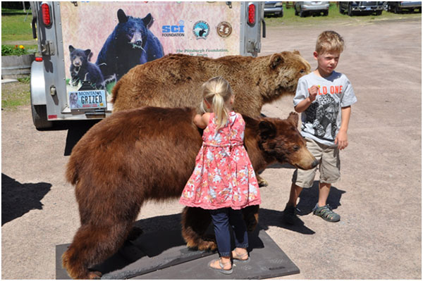 Interested young participants checking out one of the many displays at the Bear Fair