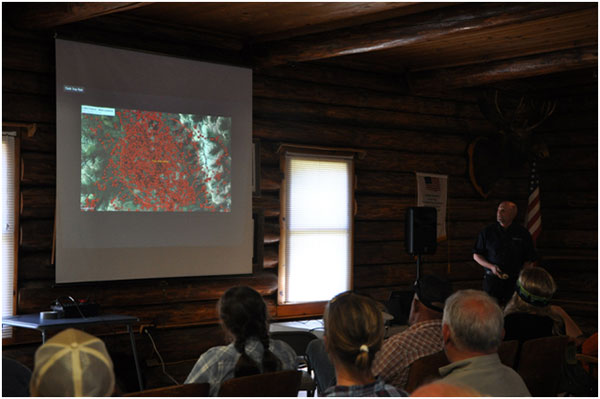 Tim Manley from Montana Fish, Wildlife, and Parks giving presentation at the Bear Fair showing slide of grizzly bear points within 5 mile radius of the Swan Valley Community Hall.