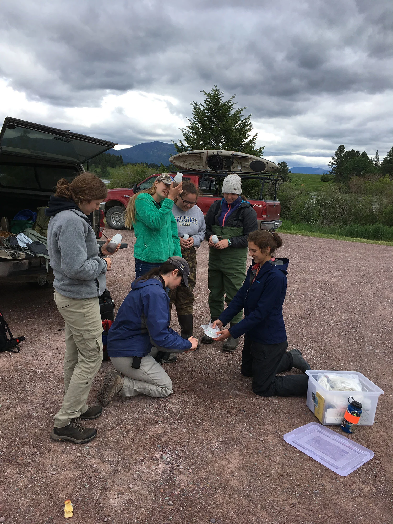 Students transfer the collected samples to a single “composite” sample that is representative of the lake, which will be sent to Montana Fish, Wildlife, & Parks for microscopy analysis. Photo: Rob Rich