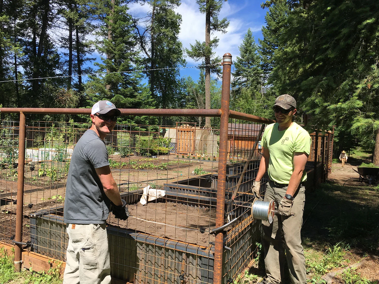 Even as Mike and Luke try to keep the tension around the challenging corners, their grins are apt proof that building a bear fence is also FUN!